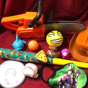 Small toys: plastic Baby Grogu bat, Space Jam ball, blue fish tub toy, etc